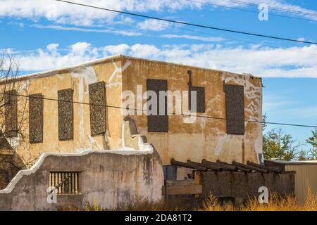 Abandoned Building With Boarded Windows In Compound Stock Photo