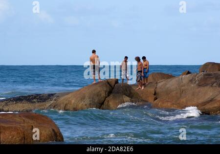 Tourists and surfers at Praia do Rosa in Imbituba, Santa Catarina Brazil - June 13, 2016. Stock Photo