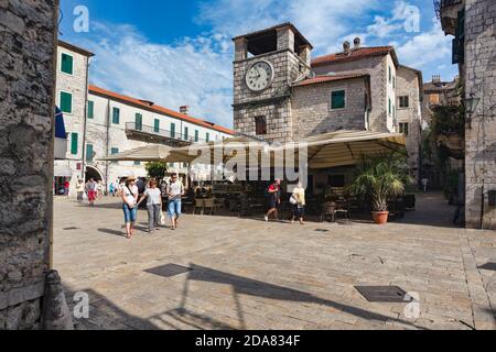 Kotor, Montenegro.  The Square of Weapons or Arms with the Clock Tower.  Kotor is part of the Natural and Culturo-Historical Region of Kotor, a UNESCO Stock Photo