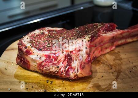 Raw Dry Aged Barbecue Tomahawk Steak ready for grill Stock Photo