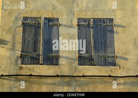 Old, weathered, painted, wooden window shutters. Stock Photo