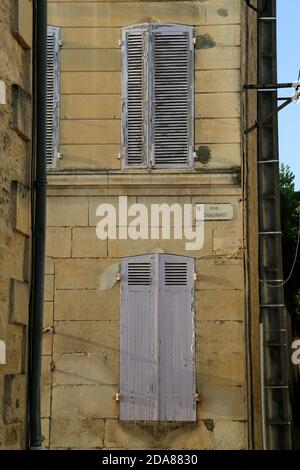 Old, weathered, painted, wooden window shutters. Stock Photo