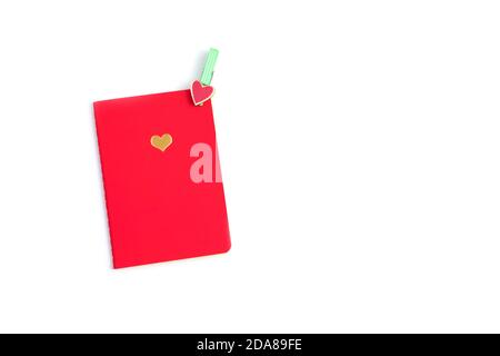 Red Notepad with heart and decorative clothespin isolated on white background. Stock Photo