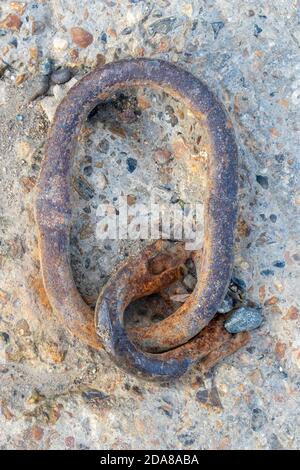 Closeup showing the texture of a old rusty chain forming the letter Q Stock Photo