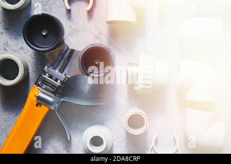 Fittings for polypropylene pipes and tools for working with plastic plumbing, heating systems and water supply. Top view Stock Photo