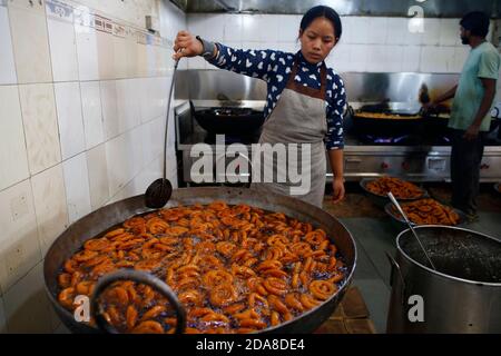 Kathmandu, Nepal. 10th Nov, 2020. A confectioner packs traditional ...