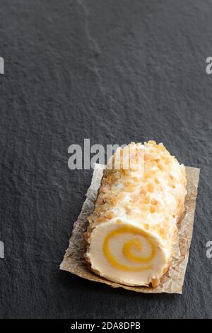 Full  fat soft cheese with pineapple and chopped almonds on black stone background Stock Photo