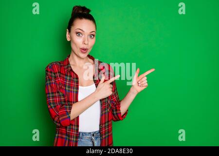 Portrait of astonished girl indicate incredible ads promotion impressed point index finger copyspace wear style stylish trendy clothes isolated over Stock Photo