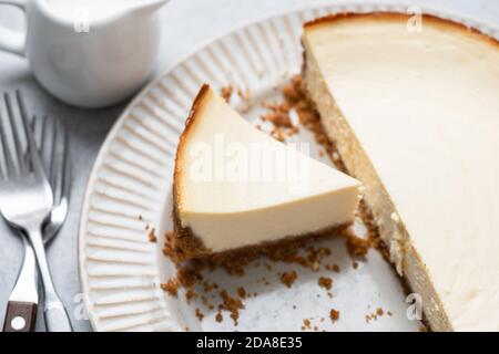 Classical new york cheesecake with slice cut out on a plate. Tasty cheesecake Stock Photo