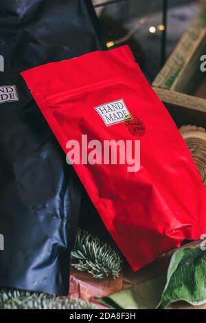 Black and red zip lock packs with hand made contents. Christmas decorations on the grey concrete background. Stock Photo