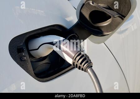 EV Car or Electric car at charging station with the power cable supply Stock Photo