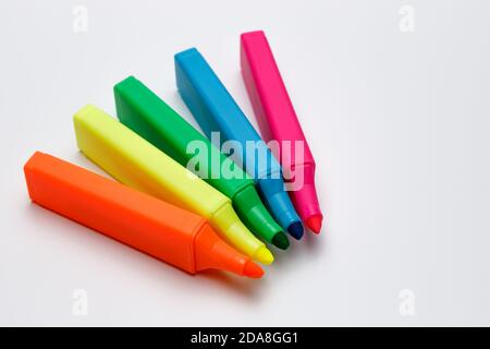 Top view of highlighter pens on white uniform background, neon colors for highlighting text, use for business presentation and meetings to point out a Stock Photo