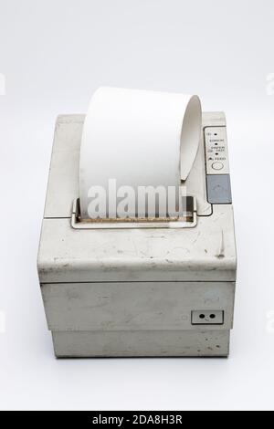 Top view of a electronic recipe printer with paper roll, old and used printer on white isolated background with dirt and grunge, connected to a cash r Stock Photo