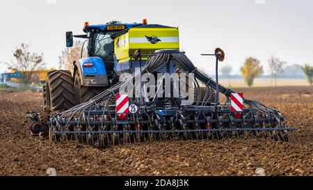 A tractor with towed seed or planter to plant seeds optimum depth and spacing Stock Photo - Alamy