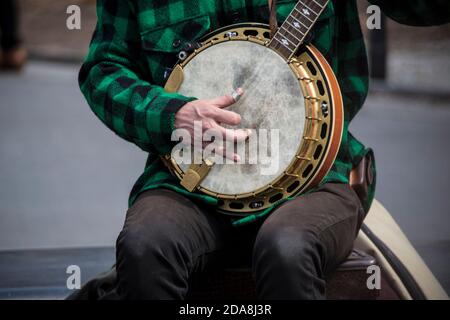 Close-up of hand of musician of the duo Coyote & Crow playing bluegrass on 5-string banjo in Washington Square Park, Greenwich Village, NYC. NY Stock Photo