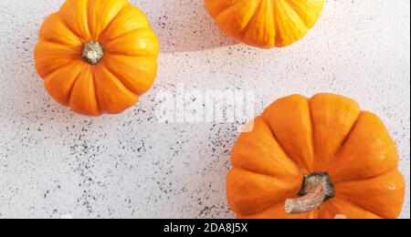Autumn composition of three orange pumpkins on Stock Photo