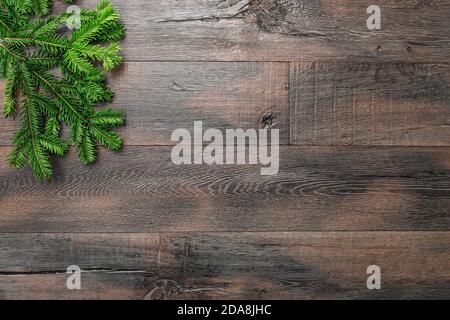 Christmas decoration on rustic wooden background. Green pine tree branches. Stock Photo