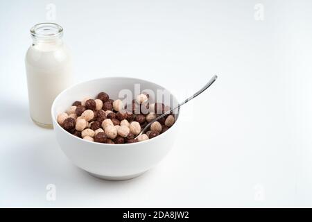 Plate with round wheat and chocolate flakes on a light background. Stock Photo