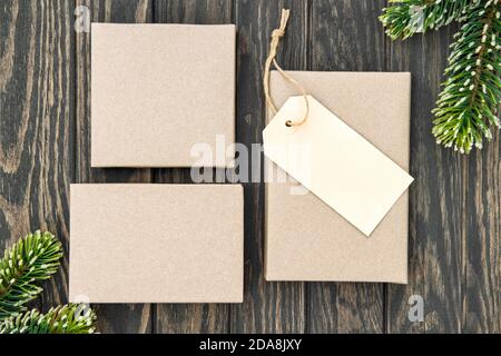 Christmas gift boxes craft paper tag on wooden background Stock Photo