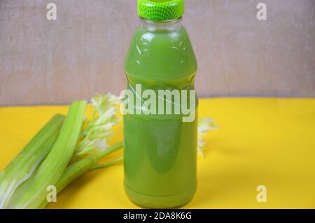 Healthy detox juice in glass bottles on soft orange yellow background. Colorful bottles. Healthy organic drink. Different tastes Stock Photo
