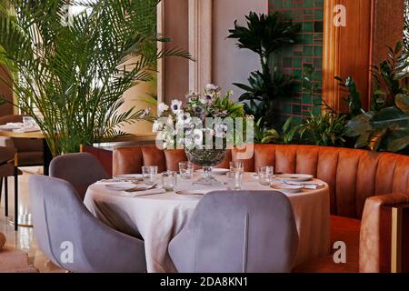 elegant dining table set with flower bouquet and cutlery Stock Photo