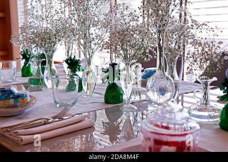 beautiful dining table set with flower bouquet and cutlery Stock Photo