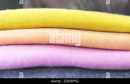 close up of colourful cashmere products, close up of colourful fabric,  a pile of cashmere textile, a stack of colourful clothes, a pile of clothes Stock Photo