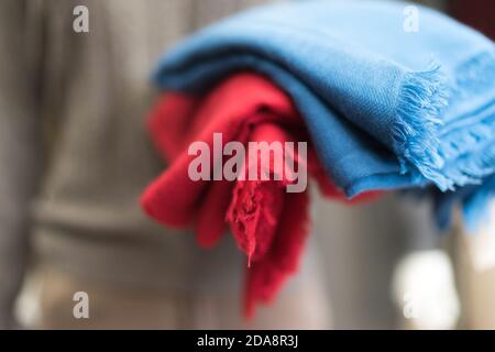 close up of colorful scarf, Close up blue and red cashmere textile clothes, woollen piece of fabric,  soft focus, blurred bokeh on a grey background Stock Photo