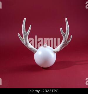 Christmas ball with reindeer horns. Christmas or New year concept. Stock Photo