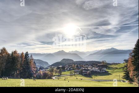 Beautiful shot of Avelango di Sopra or Hafling Obersdorf village in South Tirol, ITA in the bilingual province. Pasture with ships, dramatic sky above. Stock Photo