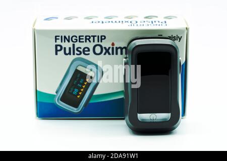 Fingertip pulse oximeter to obtain data on blood oxygen, pulse rate, and pulse strength. Isolated on white. Picture taken in Spain on November 10, 202 Stock Photo