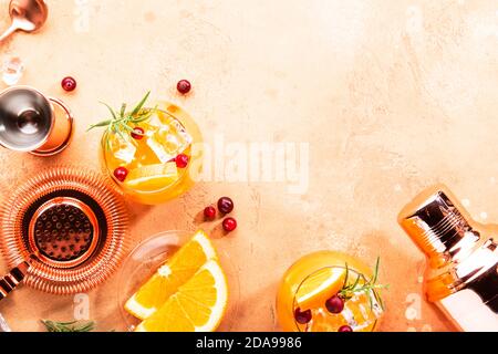 Orange Cranberry Vodka Rosemary cocktail with copper bar tools, top view Stock Photo