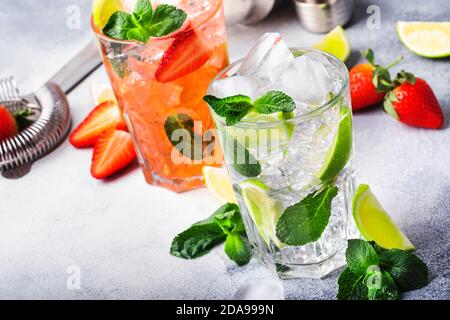Fresh Mojito mocktail set with lime, mint, strawberry and ice in glass on gray background. Cold alcoholic or non-alcoholic drinks, beverages and cockt