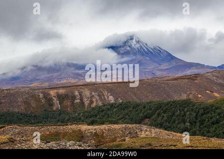 Mount Ngauruhoe in the Tongariro National Park, New Zealand. A blanket of cloud is being blown onto the mountain Stock Photo