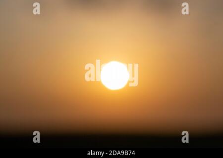 Blurry evening sun in the sky with sunset Stock Photo