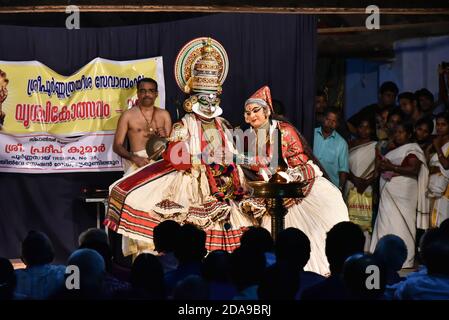 Kathakali female and male artist performing traditional dance drama folk art with face painting in temples of Kerala Onam, India. Stock Photo