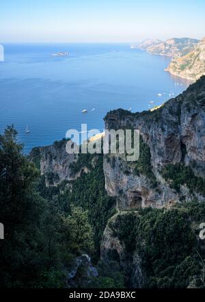 vertical view of Amalfi Coast, with Positano seaside village and beach, leisure boats moored in a bay and scenic cliffs from famous hiking path of the Stock Photo
