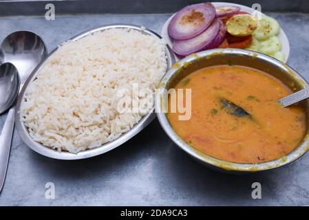 Traditional Rajasthan food thali Jaipur, India. White rice, missi , jowar roti side dish dal fry, gatta masala, baati ball, raita, churma sweet lassi Stock Photo