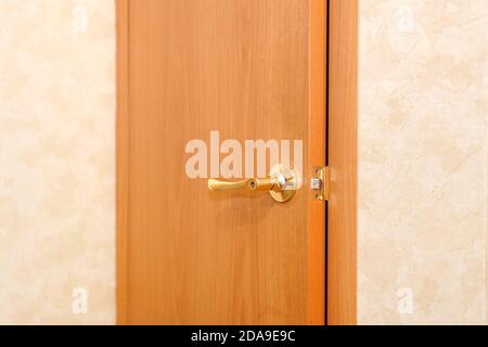 Hotel room or apartment doorway with open door. door handle close-up Stock Photo