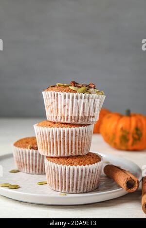 Plate with tasty pumpkin muffins on table Stock Photo