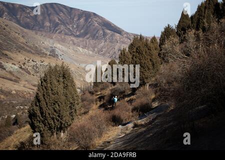 Hiking to the frozen waterfall at Issyk Ata in Kyrgyzstan's Chuy Oblast. Stock Photo