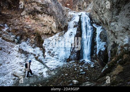 Hiking to the frozen waterfall at Issyk Ata in Kyrgyzstan's Chuy Oblast. Stock Photo