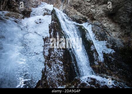 Hiking to the frozen waterfall at Issyk Ata in Kyrgyzstan's Chuy Oblast. Stock Photo