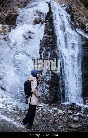 Hiking to the frozen waterfall at Issyk Ata in Kyrgyzstan's Chuy Oblast. Stock Photo