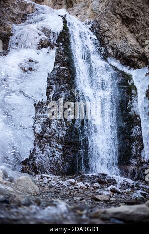 Hiking to the frozen waterfall at Issyk Ata in Kyrgyzstan's Chuy Oblast. Stock Photo