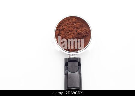 Closeup of metal holder from the coffee machine with ground coffee inside. Coffee horn and coffee filter holder Stock Photo