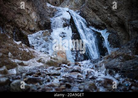 Hiking to the frozen waterfall at Issyk Ata in Kyrgyzstan's Chuy Oblast. Stock Photo