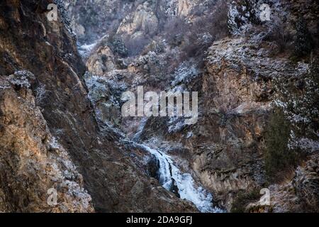 Hiking to the frozen waterfall at Issyk Ata in Kyrgyzstan's Chuy Oblast. Stock Photo