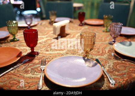 Dining table set with plates in restaurant Stock Photo