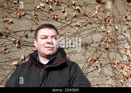 Portrait of man on concrete wall background Stock Photo